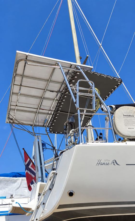 Stainless solar arch carrying panels on a yacht stern