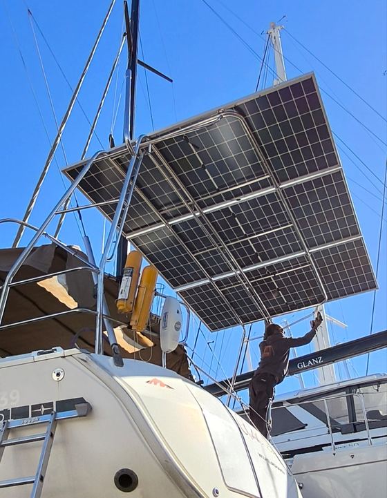 Solar panel array being fitted to a stainless arch