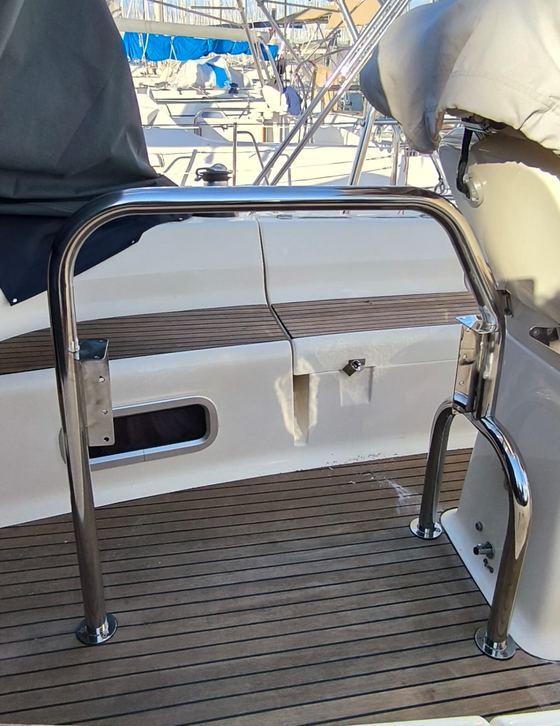 Stainless boarding gate on a teak side deck